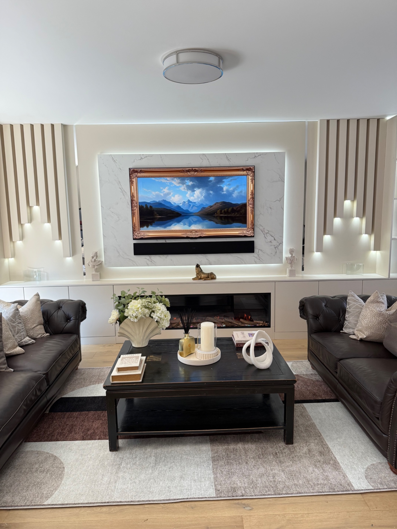 Symmetrical living room with fluted feature wall and twin leather sofas
