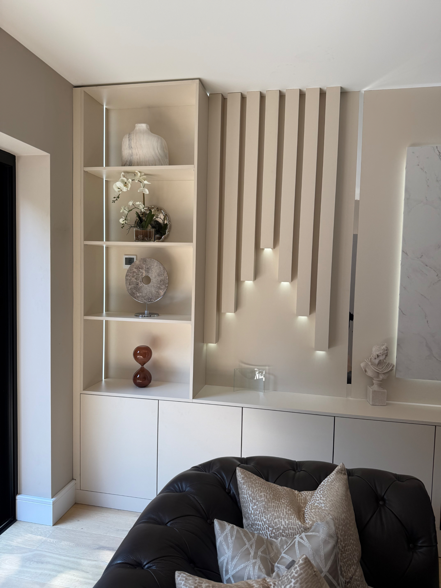 Bespoke shelving with fluted feature wall and curated objets